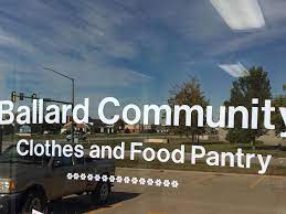 A reflective glass door with the words "Ballard Community Clothes and Food Pantry" written on it.